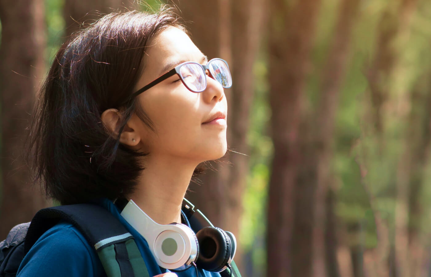 Person walking through woods to destress