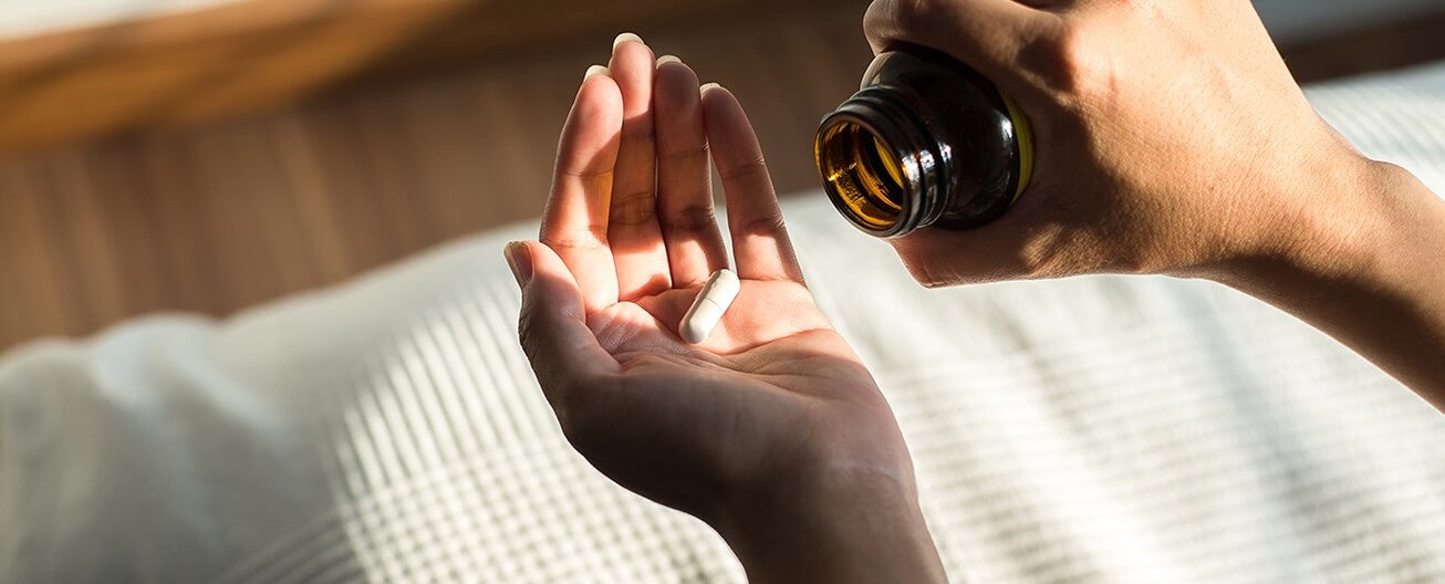 Pouring medication out on hand