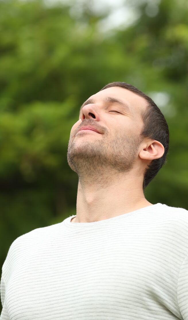 Man outdoors practicing breathwork